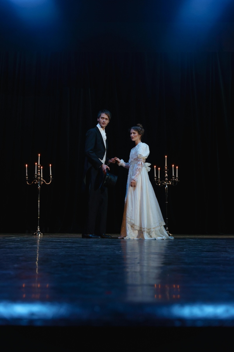 image of two period actors holding hands on stage